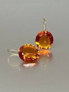 Gorgeous Madeira Citrine drops earrings. The oval  Madeira Citrine drops are eye clean, flawless, and have a beautiful rich golden whiskey color. The drops are attached to 24k gold vermeil /14K SOLID GOLD ear wires. The earrings are elegant, have a lux look, and make a statement.  A truly gorgeous pair of earrings. When 14K SOLID GOLD ear wires are being used, the ear wire ends are hand-stamped as proof of being 14K solid gold. In addition, extra work was done at the end of the ear wires to prev Luxury Citrine Earrings, Luxury Orange Drop Earrings, Formal Round Citrine Earrings, Orange Gemstone Drop Jewelry, Orange Drop Gemstone Jewelry, Formal Drop Citrine Jewelry, Formal Orange Gemstone Earrings, Fine Jewelry Briolette Faceted Earrings, Elegant Drop Citrine Earrings