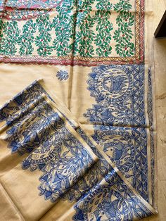 Authentic Handpainted Madhubani Handwoven Tussar Silk Saree. This saree has a depiction of lady from mithila, full of plants colourful artwork design on the centre of aanchal, borders have madhubani fishes  painted on it with indigo. This saree comes with running blouse fabric with minimal artwork on it .  Craft - Madhubani Paints Color -Beige Material -Tussar Silk Blouse piece - yes Luxury Tussar Silk Dupatta With Woven Motifs, Luxury Tussar Silk Fabric With Traditional Patterns, Luxury Festive Tussar Silk Digital Prints, Madhubani Saree Designs, Bohemian Tussar Silk Saree For Festivals, Artistic Handloom Chanderi Dupatta, Artistic Tussar Silk Saree For Festivals, Bohemian Tussar Silk Saree With Pallu, Artistic Handloom Katan Silk Dupatta