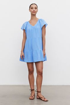 Crafted from a soft airy cotton gauze for optimal comfort. Its tiered silhouette and v-neckline adds an effortless feel. Finished with lightly frilled flutter sleeves, this dress delivers a unique touch of style. Cotton Gauze Dress, Velvet Tees, Gauze Dress, Flutter Sleeves, Tiered Dress, Flutter Sleeve, Oversized Fits, Blue Dresses, Velvet