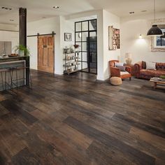 a living room filled with furniture and wooden floors