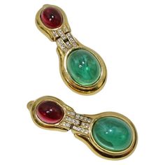 Eye catching 1980s gold plated Ciner earrings featuring the most gorgeous and vibrant red and green stones at the center! Classic drop style earring in the perfect size as to draw in the eye without making too big of a statement. Stunning yellow gold compliments the stones beautifully and is offset by small circular rhinestones in the center. These are the perfect earrings to pull out when you are looking for a subtle pop of color for your look but still want to keep things effortless and refine Luxury Multi-stone Gold Earrings, Vintage Jeweled Multicolor Earrings, Luxury Round Citrine Earrings, Luxury Vintage Gold-tone Earrings, Luxury Vintage Red Clip-on Earrings, Green Stone, Gold Plated Earrings, Red And Gold, Vibrant Red