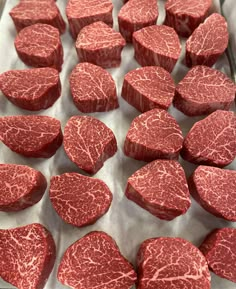 raw steaks are arranged on a baking sheet