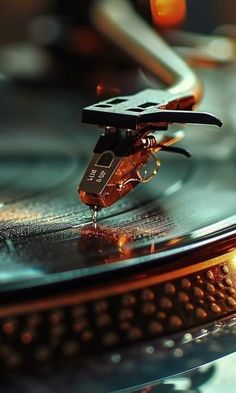 an old record player with its turntable spinning on it's side and some lights in the background