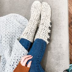 a woman laying on top of a couch with her legs crossed