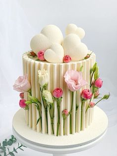 there is a cake decorated with flowers and marshmallows