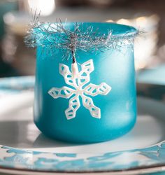 a blue cup with a snowflake decoration on it