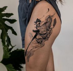 a woman with a tattoo on her thigh