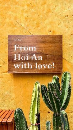 a sign that says from hoi an with love next to some cacti