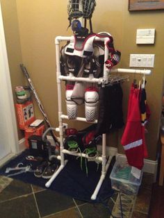 a hockey goalie's gear is displayed on a rack in the corner of a room