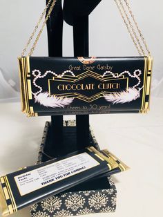 a black and gold purse sitting on top of a table next to a card holder