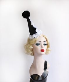 Black and White Clown Hat, Cirque Costume, Birthday Party Hat, Kids, Adults, Carnival, Burlesque Headpiece, Circus Hair Accessory This mini clown hat is made from black and white satin that has been put on half and half, over a buckram frame that has been also covered in felt- so it's super sturdy and has a perfectly smooth surface. It has gorgeous trim of ruffled white satin with two pom poms up the front and a huge handmade pom pom at the top. It comes on a headband that goes through elastic o