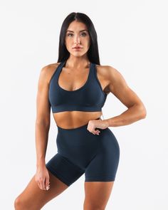 HIGHLIGHTS. Seamless construction Rib panel to contour and support Low to Medium impact Moisture-wicking breathable fabric Flattering scoop neckline A/B/C cup size FIT SUGGESTION. This item runs true to Alphalete's standard seamless fit.. We recommend sizing up for a comfortable fit.. Brooke is 5’5”/165cm, wearing a size S with a 35”/88.9cm bust. Hannah is 5'11/180.3cm, wearing a size L with a 42.5"/108cm bust. MATERIALS AND WASHING DIRECTIONS. 51% Polyamide, 38% Polyester, 11% Elastane. We reco Seamless Scoop Neck Activewear For Workout, Supportive Seamless Scoop Neck Activewear, Supportive Scoop Neck Activewear For Sports, Blue Racerback Sports Bra With Medium Bust Support, Seamless Scoop Neck Activewear With Medium Support, Seamless Scoop Neck Sports Bra For Training, Breathable Fitted Sports Bra With Scoop Neck, Blue Activewear With Medium Bust Support For Workout, Gym Activewear With Medium Bust Support And Scoop Neck