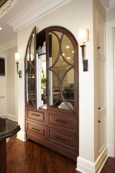 a large wooden cabinet sitting in the middle of a room