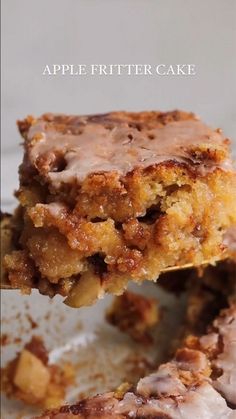 a piece of apple fritter cake is being held up by a spatula