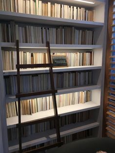 a ladder leaning up against a bookshelf filled with lots of books