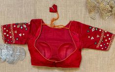 Stunning red mirror work saree blouse. Buy designer blouse in USA from Pure Elegance. Disclaimer: The actual product may vary slightly from the image. These are custom orders, hence expect slight variation in color, placement of the motif or buta. ESTIMATED DELIVERYBecause this is a custom order, it would take about 4 weeks from the date of purchase. RETURN POLICY: This product is a custom order and cannot be returned or exchanged. Red Mirror Work Blouse For Wedding, Red Wedding Blouse With Mirror Work, Red Mirror Work Blouse Piece, Semi-stitched Red Chanderi Blouse Piece, Red Mirror Work Top For Wedding, Fitted Red Blouse With Mirror Work, Transitional Fitted Saree With Mirror Work, Red Wedding Top With Mirror Work, Red Mirror Work Blouse For Festive Occasions