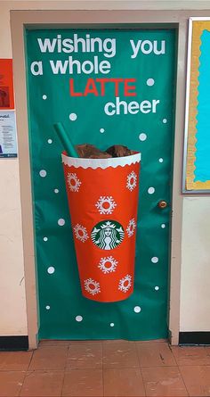 a starbucks cup is on display in front of a door that says, wishing you a whole latte cheer