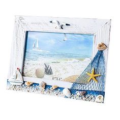 a white frame with seashells and starfish on the beach