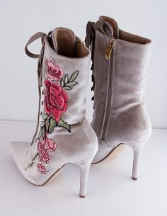 Our SISITINE booties have flowers embroidered onto its velvet outer shell and gold metal accents. Heel height: 4.2" Luxury Elegant Embroidered Boots, Unique Shoes Lyst, Gold Accented Shoes, Spring Luxury Formal Heeled Boots, Luxury Spring Formal Heeled Boots, Elegant Embellished Boots For Spring, Elegant Embellished Spring Boots, Spring High Heel Boots With Floral Embroidery, Embroidered High Heel Boots For Spring