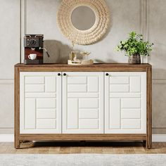 a white and brown sideboard in a room with a mirror on the wall above it