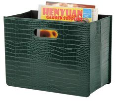 a green crocodile print storage bin with magazine holders and magazines in the bottom compartment, on a white background