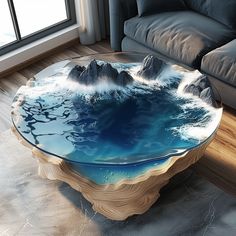 a glass table with mountains on it in front of a couch