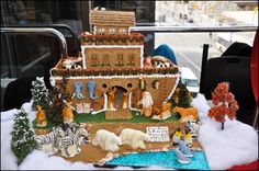 a gingerbread house with animals and people on it