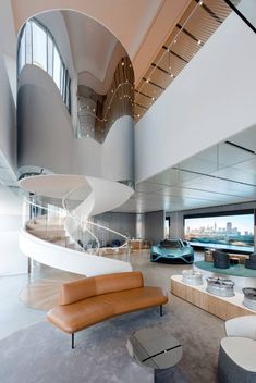 the interior of a modern building with curved stairs