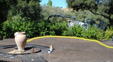 a large vase sitting on top of a dirt field