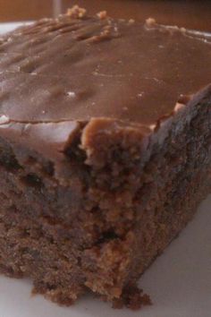 a piece of chocolate cake sitting on top of a white plate