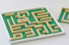 two lego mazes sitting on top of a table