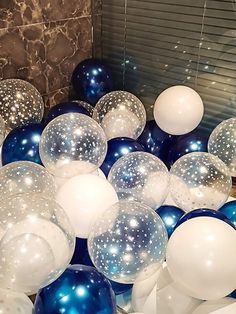 blue and white balloons are scattered on the floor