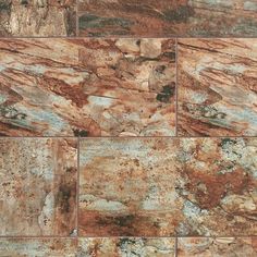 a close up view of some brown and blue marble tiles on a wall or floor