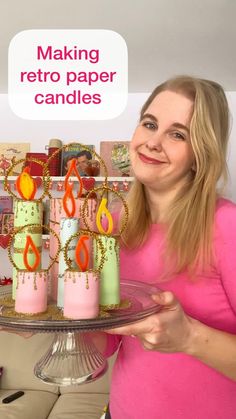 a woman holding a cake with candles on it and the words making retro paper candles