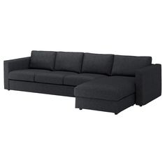 a black sectional couch sitting on top of a white floor