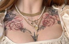 a woman with tattoos on her chest is wearing pearls and gold necklaces that are attached to her chest