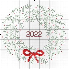 a cross stitch christmas wreath with the year 2012 written in red and green on it