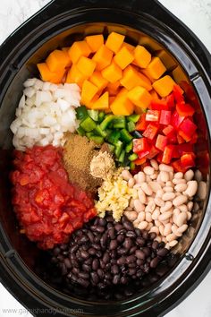 the ingredients in this slow cooker include beans, carrots, onions, and peppers