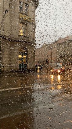 rain drops on the window as cars drive by