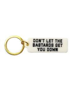 Don't let 'em get to ya, a handy reminder to carry with you all day.Simple, classic tag keychainGlossy durable, hard plastic bodyDesign printed on one sideWould work great as a bag pull, too!Measurements: 2" x .75" w/out key ringBy Golden Gems Cool Accessories, Vintage Hotel, House Keys, Key Tags, Zulu, Bits And Bobs, Pretty Words, Hard Plastic, Things To Buy