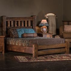 a bed sitting in a bedroom next to a wooden dresser and chair with a lamp on top of it