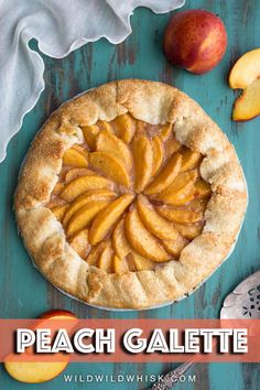 an apple pie on a blue table with sliced apples