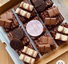 a box filled with lots of chocolates on top of a table