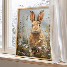 a painting of a rabbit is on the window sill