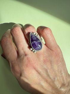 Amethyst on a patterned sterling silver ring band. Size 6.75-7. Amethyst Open Ring With Accent Stones, Silver Amethyst Rings Fine Jewelry, Silver Open Ring Amethyst With Stone Setting, Fine Jewelry Amethyst Silver Rings, Silver Amethyst Rings With Stone Setting, Silver Amethyst Open Ring With Stone Setting, Classic Handmade Amethyst Jewelry, Unique Amethyst Ring With Accent Stones, Teardrop Amethyst Ring In Purple