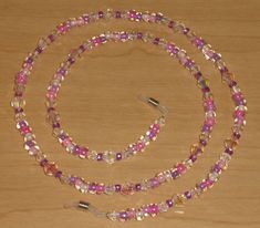 a beaded necklace and bracelet on a wooden surface