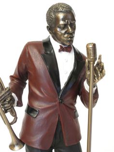 a statue of a man in a tuxedo holding a trumpet