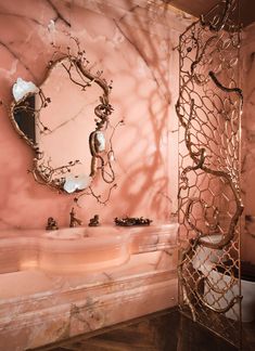 a bathroom with pink walls and marble counter tops