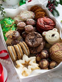 a box filled with lots of different types of cookies and pastries on top of a table