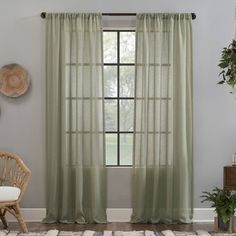 a living room scene with focus on the curtains and rug in front of the window